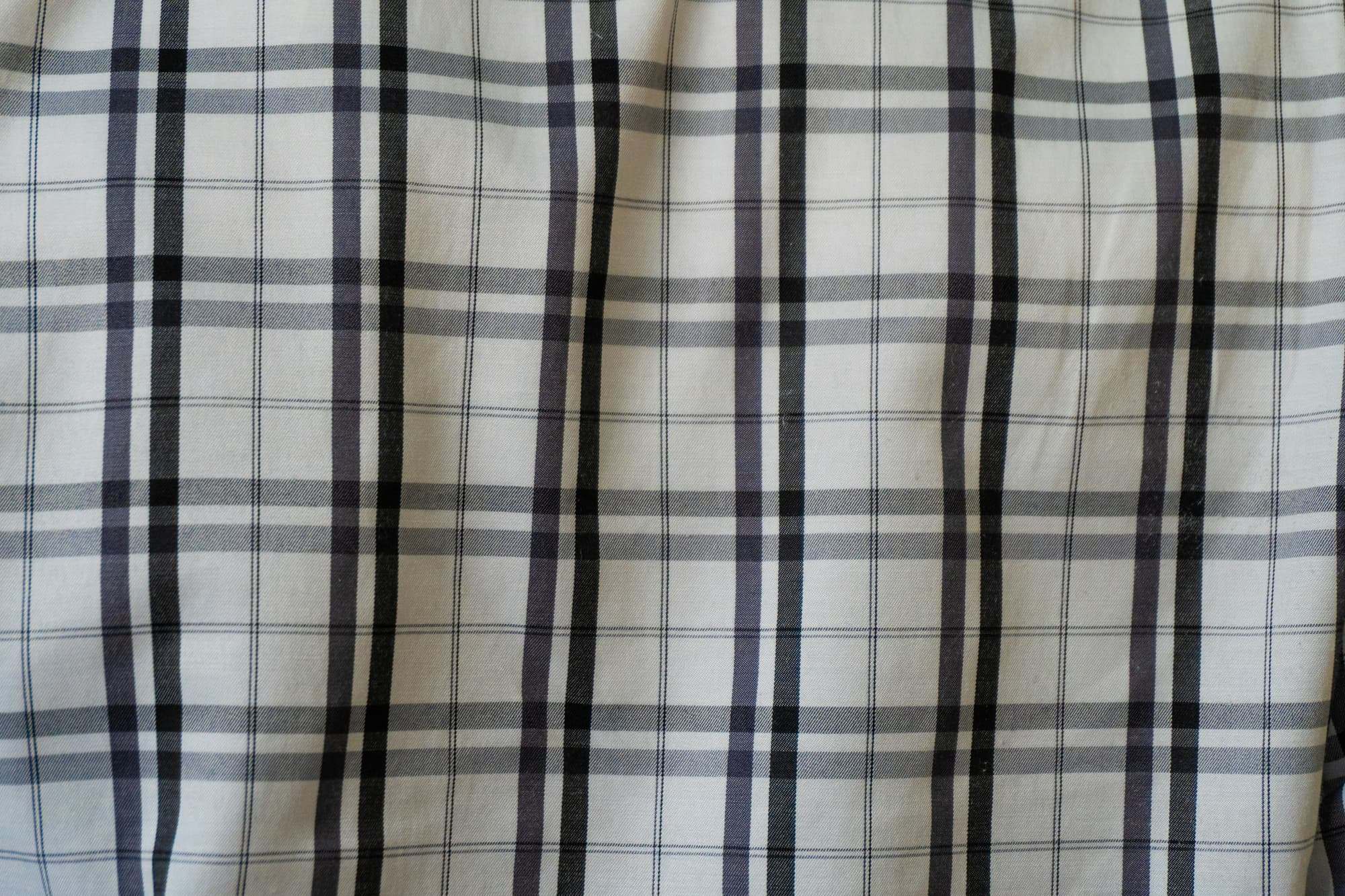 White cloth with a grey and black check