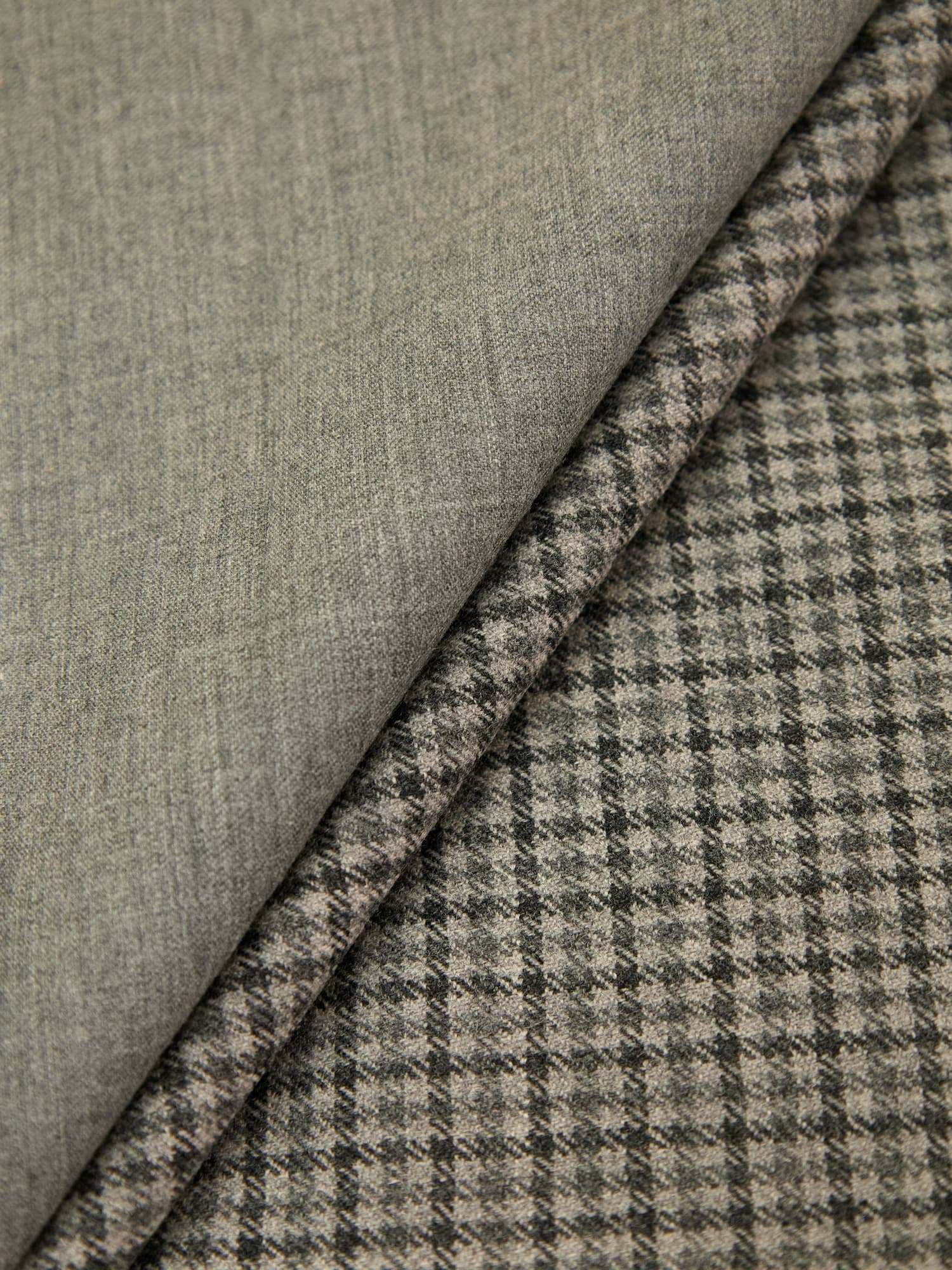 Grey houndstooth fabric over a plain grey twill