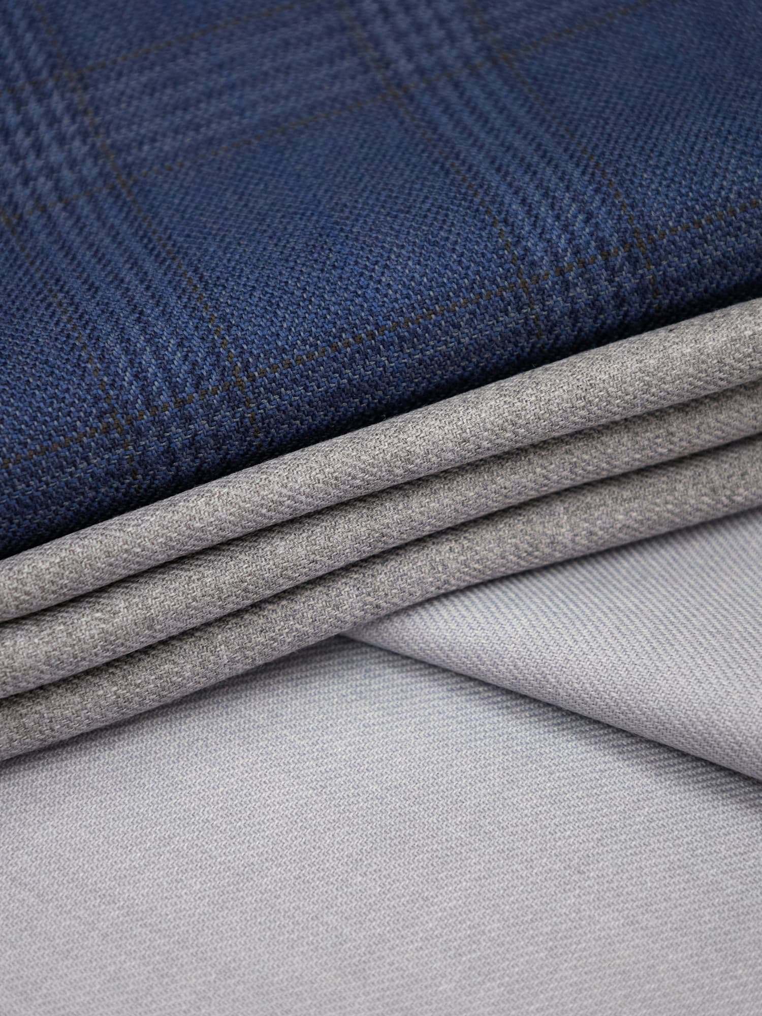 Navy check and grey twill fabric laid in folds