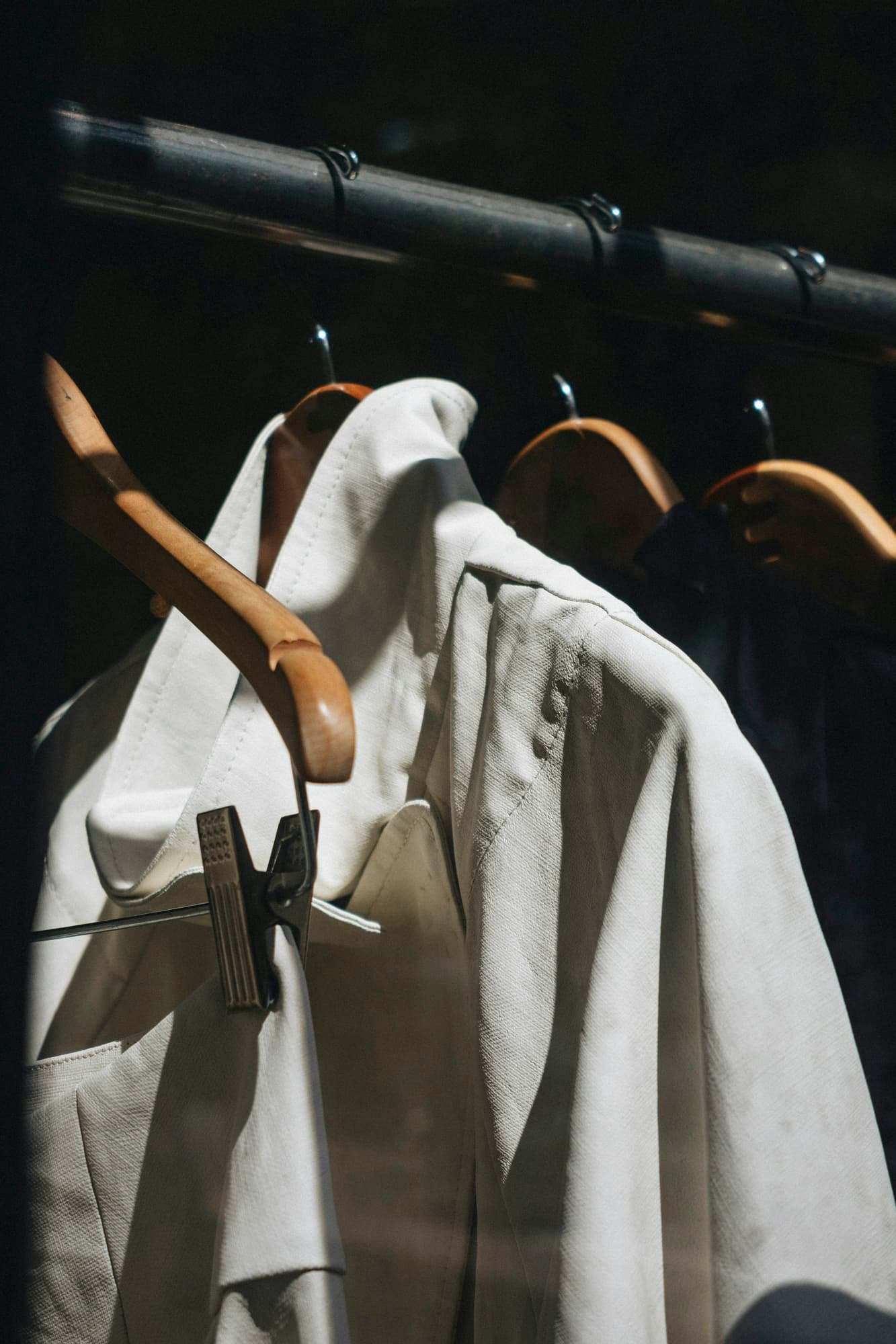 A white shirt on a wooden hanger in raking light